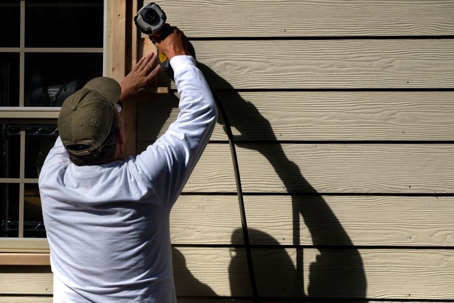 Carpenter Installing Siding